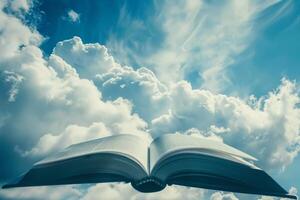 Open book floating in cloudy sky representing freedom, knowledge, and spirituality photo