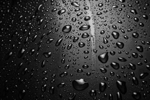 Water droplets forming on a smooth surface creating an abstract pattern photo