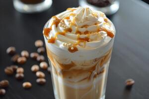Caramel coffee latte being topped with whipped cream and caramel drizzle photo