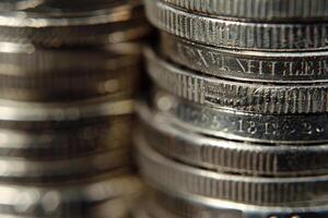 Close up of stack of silver coins showing increasing value photo