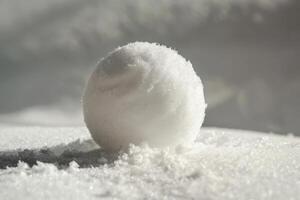 Pristine snowball in sunlit winter scene photo
