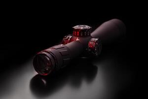 Modern sniper scope on a dark back. Optical device for aiming and shooting at long distances. photo