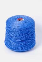 Blue bobbin of yarn on a white background.Textile reel on isolated white background. photo