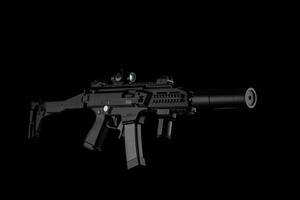 Modern automatic rifle isolated on black background. Weapons for police, special forces and the army. A carbine with optical, mechanical sights and a silencer on a dark back photo