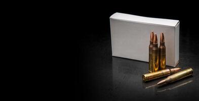 Bullet isolated on black background with reflexion. Rifle bullets close-up on black back. Cartridges for rifle and carbine on a black. photo