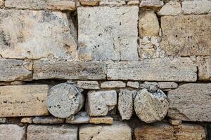 Brick wall of yellow shell rock. Closeup of shellstone texture. Background wall with shell rock. Texture limestone. Old wall. photo