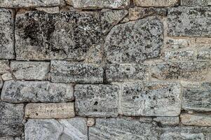 The texture of the old wall. Vintage brick back. The wall is made of shell rock of various rectangular shapes. photo
