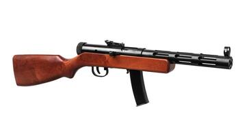 Vintage submachine gun from the Second World War. Automatic weapon with a wooden butt. Isolate on a white back. photo