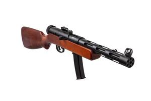 Vintage submachine gun from the Second World War. Automatic weapon with a wooden butt. Isolate on a white back. photo