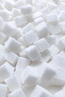 Rafinated sugar. Textured white background from sugar cubes. photo