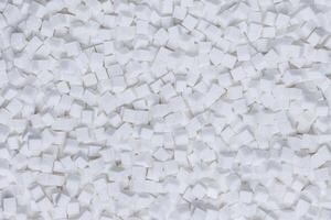 Rafinated sugar. Textured white background from sugar cubes. photo
