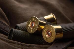 Shotgun shells close-up. Ammunition for smoothbore weapons on a khaki canvas backpack. Dark back photo