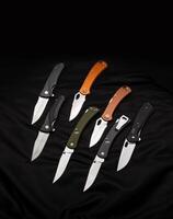 Various folding pocket knives on a dark back. A versatile pocket tool and self-defense tool. photo