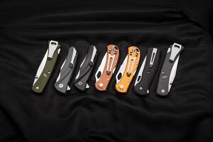 Various folding pocket knives on a dark back. A versatile pocket tool and self-defense tool. photo