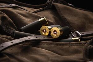 Shotgun shells close-up. Ammunition for smoothbore weapons on a khaki canvas backpack. Dark back photo