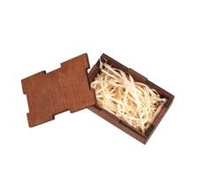Open wooden box with filling material inside. Empty natural wooden box with decorative straw for happy gifts. photo