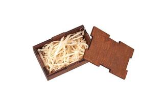 Open wooden box with filling material inside. Empty natural wooden box with decorative straw for happy gifts. photo