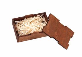 Open wooden box with filling material inside. Empty natural wooden box with decorative straw for happy gifts. photo