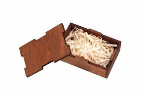 Open wooden box with filling material inside. Empty natural wooden box with decorative straw for happy gifts. photo
