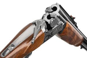 Luxury double-barreled shotgun with a vertical arrangement of barrels. Expensive weapon for hunters. Isolate on a white back. photo