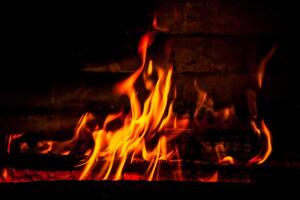 firewood burning fire on a black background photo