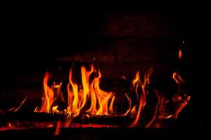 firewood burning fire on a black background photo