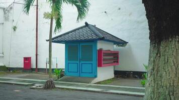 Colorful Kiosk with Palm Tree in Urban Setting video
