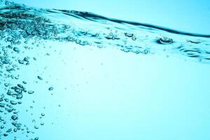 Fresh Water With Underwater Bubbles Texture on a Blue Background Close-up Abstract Liquid Bubbles Aqua Design Wallpaper photo