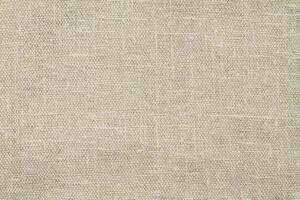 Natural Linen Material Textile Canvas Fabric Texture Background Close-up Detail of Fabric Natural Color Hemp Material Pattern Design Wallpaper. Can be Used as Background or For Graphic Design photo
