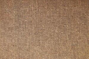 Natural Linen Material Textile Canvas Fabric Texture Background Close-up Detail of Fabric Natural Color Hemp Material Pattern Design Wallpaper. Can be Used as Background or For Graphic Design photo