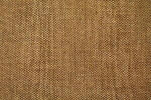 Natural Linen Material Textile Canvas Fabric Texture Background Close-up Detail of Fabric Natural Color Hemp Material Pattern Design Wallpaper. Can be Used as Background or For Graphic Design photo