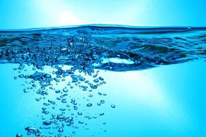 Fresh Water With Underwater Bubbles Texture on a Blue Background Close-up Abstract Liquid Bubbles Aqua Design Wallpaper photo