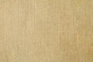 Natural Linen Material Textile Canvas Fabric Texture Background Close-up Detail of Fabric Natural Color Hemp Material Pattern Design Wallpaper. Can be Used as Background or For Graphic Design photo
