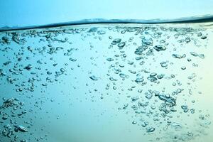 Fresh Water With Underwater Bubbles Texture on a Blue Background Close-up Abstract Liquid Bubbles Aqua Design Wallpaper photo
