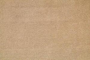 Natural Linen Material Textile Canvas Fabric Texture Background Close-up Detail of Fabric Natural Color Hemp Material Pattern Design Wallpaper. Can be Used as Background or For Graphic Design photo
