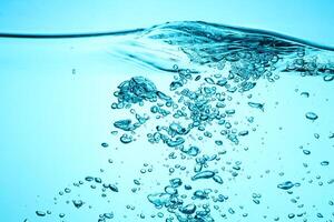 Fresh Water With Underwater Bubbles Texture on a Blue Background Close-up Abstract Liquid Bubbles Aqua Design Wallpaper photo