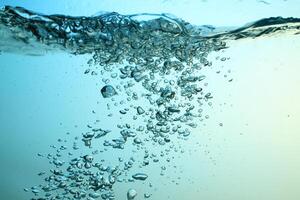 Fresh Water With Underwater Bubbles Texture on a Blue Background Close-up Abstract Liquid Bubbles Aqua Design Wallpaper photo
