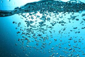 Fresh Water With Underwater Bubbles Texture on a Blue Background Close-up Abstract Liquid Bubbles Aqua Design Wallpaper photo