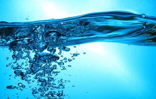 Fresh Water With Underwater Bubbles Texture on a Blue Background Close-up Abstract Liquid Bubbles Aqua Design Wallpaper photo