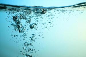 Fresh Water With Underwater Bubbles Texture on a Blue Background Close-up Abstract Liquid Bubbles Aqua Design Wallpaper photo