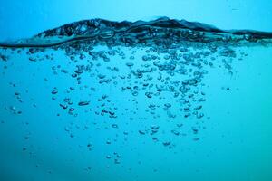 Fresh Water With Underwater Bubbles Texture on a Blue Background Close-up Abstract Liquid Bubbles Aqua Design Wallpaper photo
