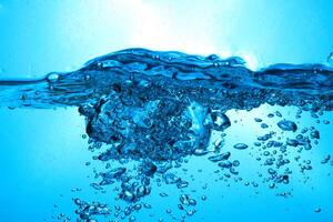 Fresh Water With Underwater Bubbles Texture on a Blue Background Close-up Abstract Liquid Bubbles Aqua Design Wallpaper photo