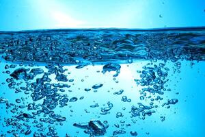 Fresh Water With Underwater Bubbles Texture on a Blue Background Close-up Abstract Liquid Bubbles Aqua Design Wallpaper photo