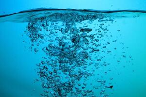 Fresh Water With Underwater Bubbles Texture on a Blue Background Close-up Abstract Liquid Bubbles Aqua Design Wallpaper photo