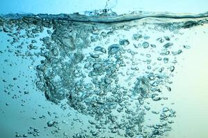 Fresh Water With Underwater Bubbles Texture on a Blue Background Close-up Abstract Liquid Bubbles Aqua Design Wallpaper photo