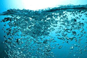Fresh Water With Underwater Bubbles Texture on a Blue Background Close-up Abstract Liquid Bubbles Aqua Design Wallpaper photo