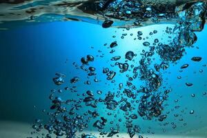 Fresh Water With Underwater Bubbles Texture on a Blue Background Close-up Abstract Liquid Bubbles Aqua Design Wallpaper photo