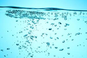 Fresh Water With Underwater Bubbles Texture on a Blue Background Close-up Abstract Liquid Bubbles Aqua Design Wallpaper photo