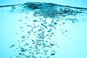 Fresh Water With Underwater Bubbles Texture on a Blue Background Close-up Abstract Liquid Bubbles Aqua Design Wallpaper photo