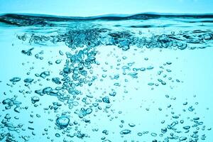 Fresh Water With Underwater Bubbles Texture on a Blue Background Close-up Abstract Liquid Bubbles Aqua Design Wallpaper photo